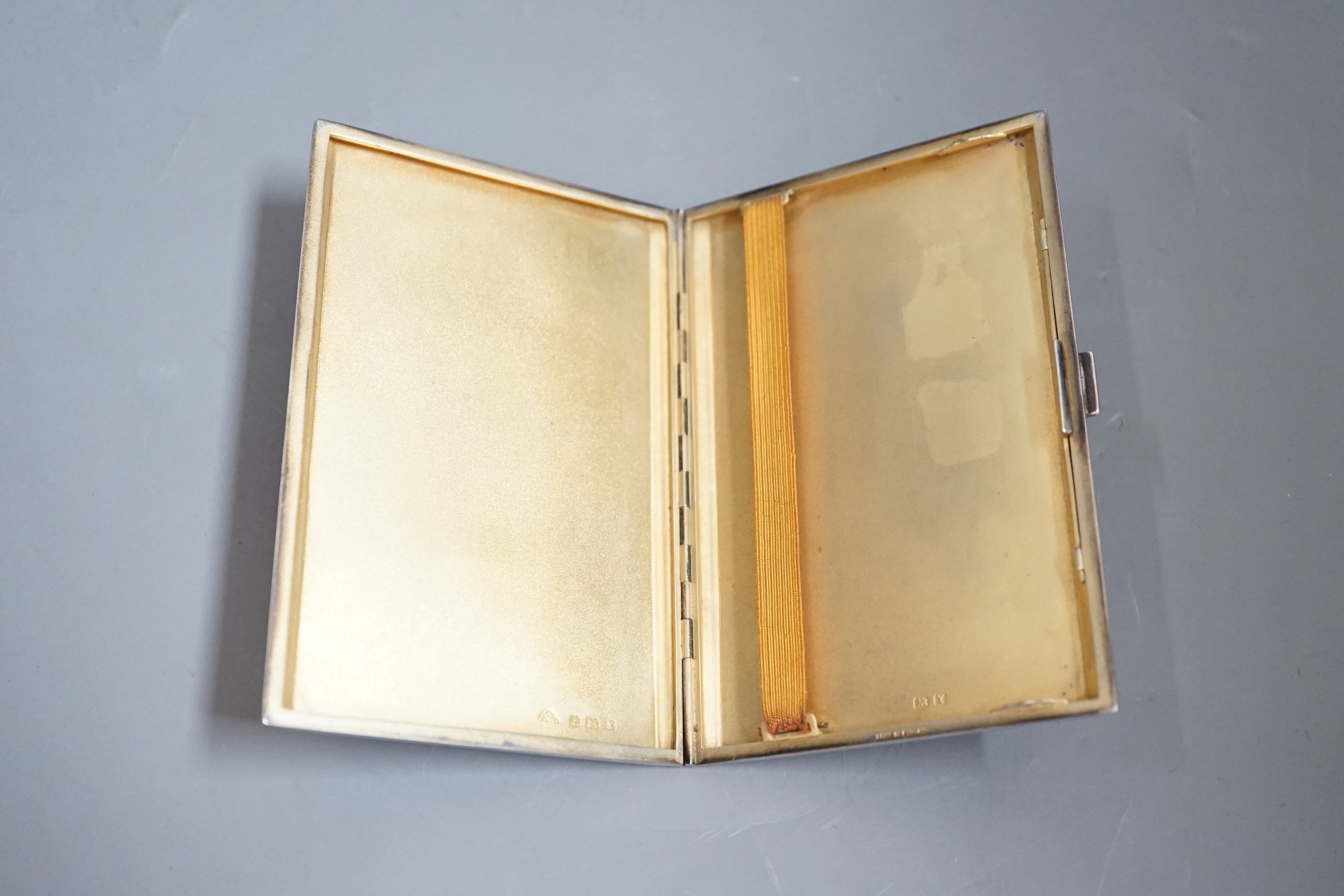 A George V engine turned silver rectangular cigarette case, 12.2cm, with engraved initials.